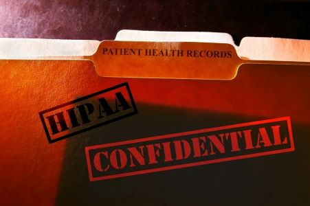 HIPAA-compliant folder marked 'Confidential' for patient health records.