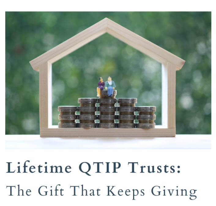 Mini couple on coins inside a wooden house frame